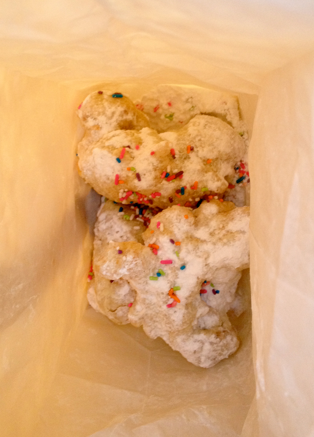 Zeppole in the bag with powered sugar and sprinkles
