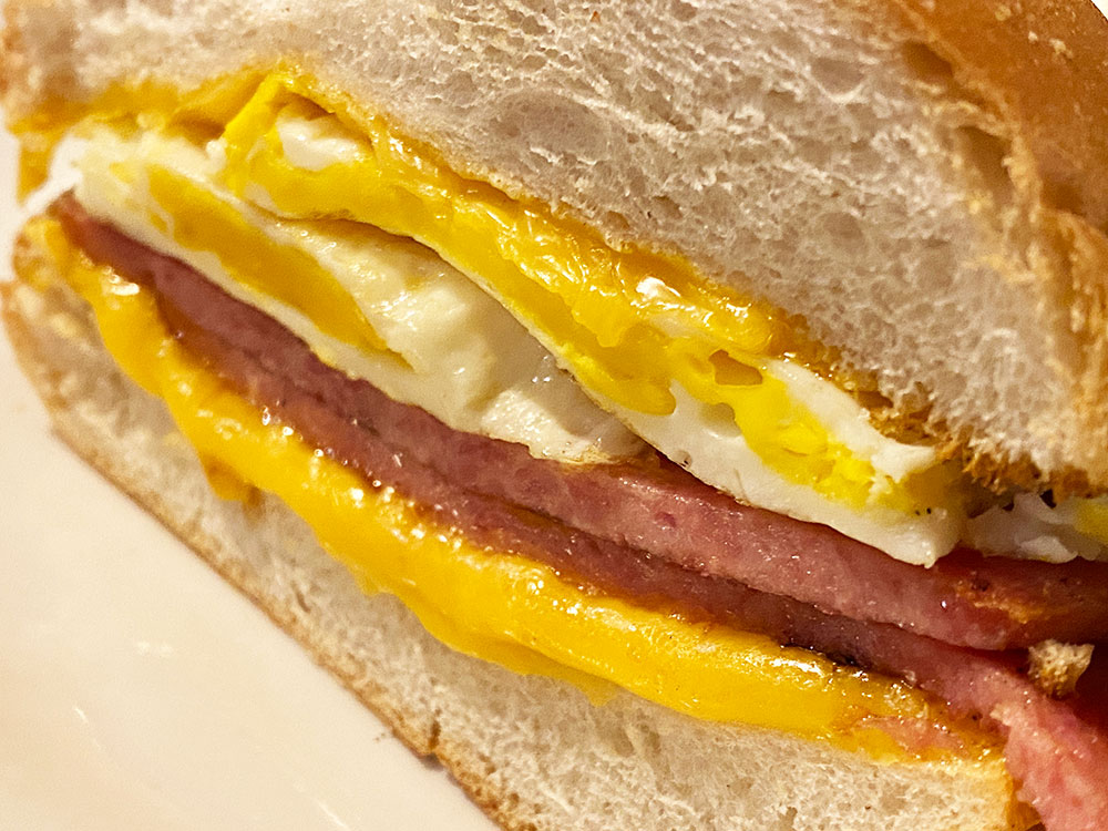 cross section of the taylor ham egg and cheese sandwich but on an angle from a diner