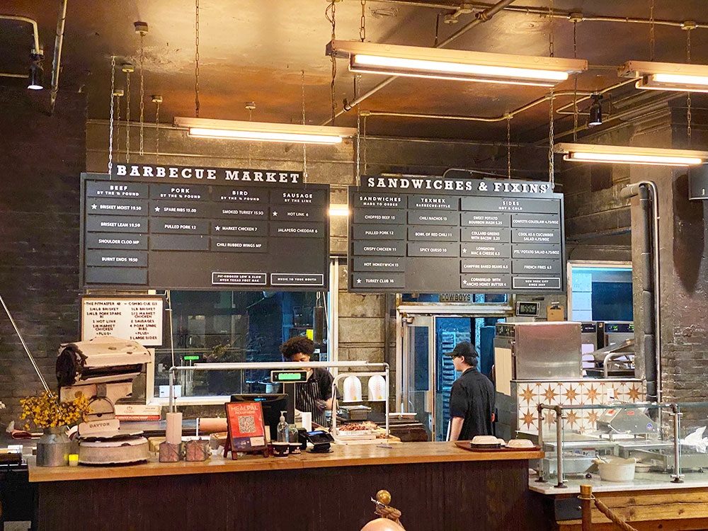 Hill Country Market has an open kitchen with lists of meats