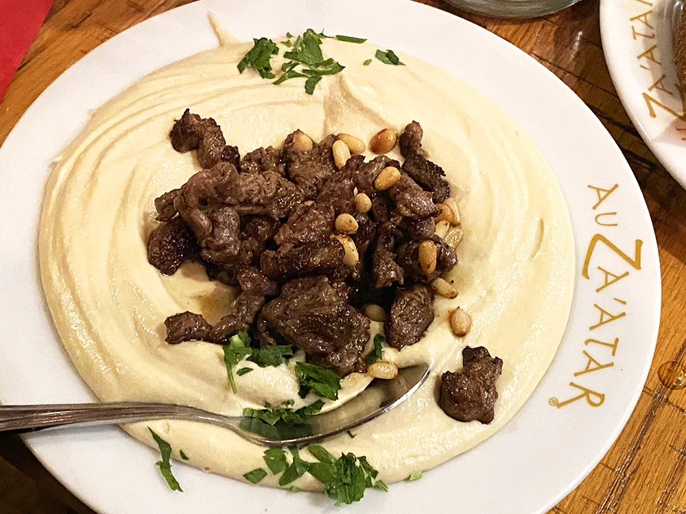 hummus and lamb chunks with pine nuts