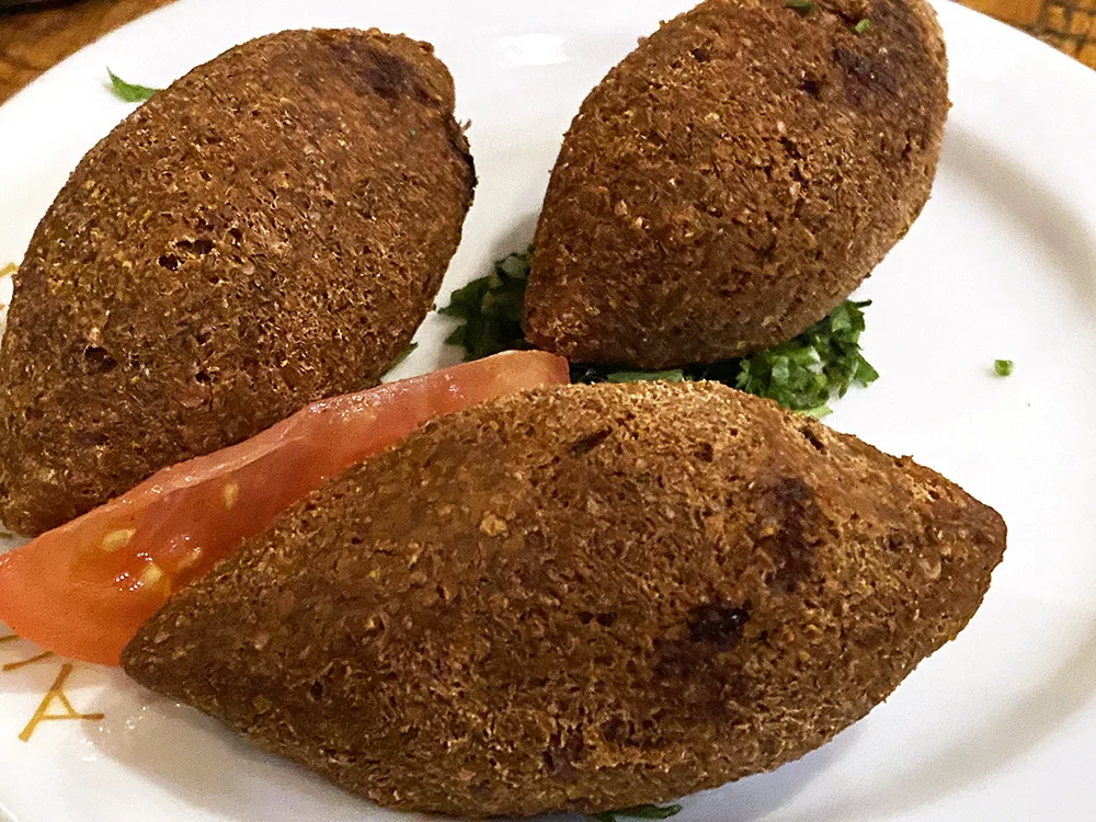 Kibbeh Krass, football shaped pastry made with bulgur wheat