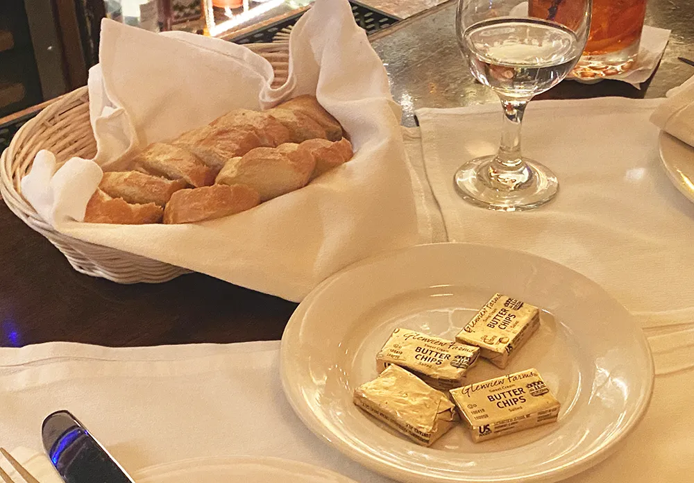 Traditional bread service with single wrapped pats of butter