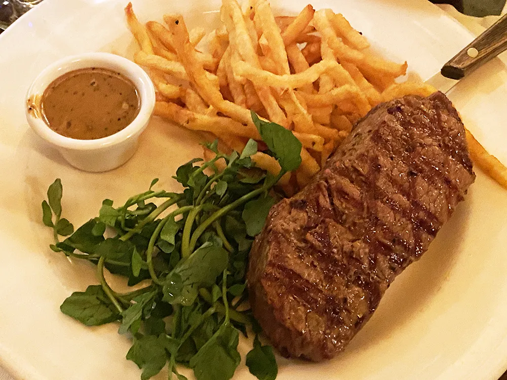 Steak, fries, pepper sauce and watercress